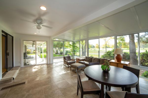 An Interior of a Living Room Surrounded by Glass Windows